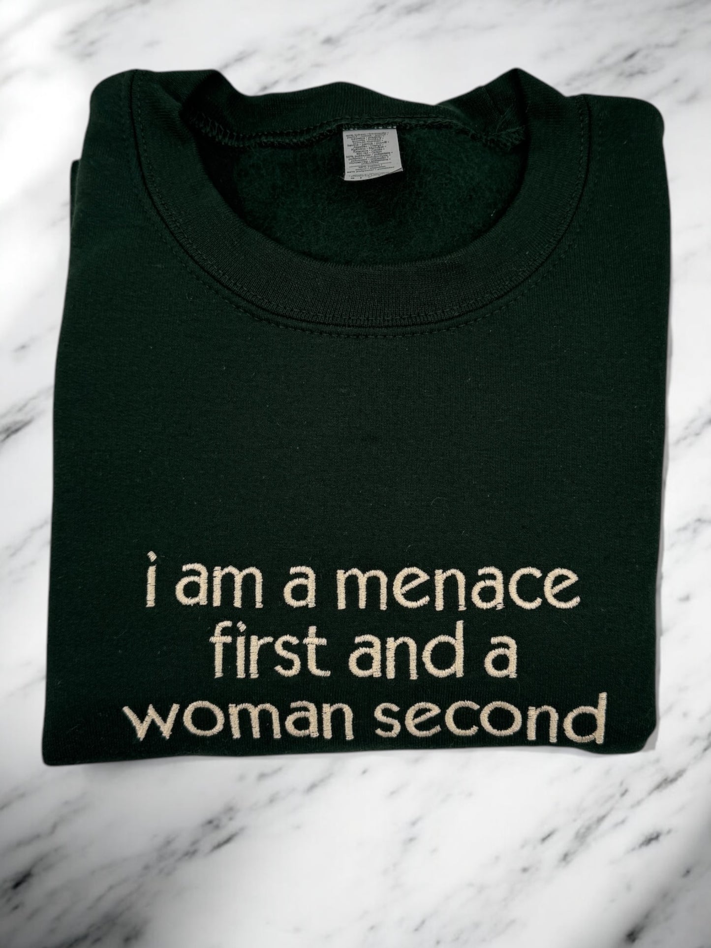 a t - shirt that says i am a menache first and a woman second