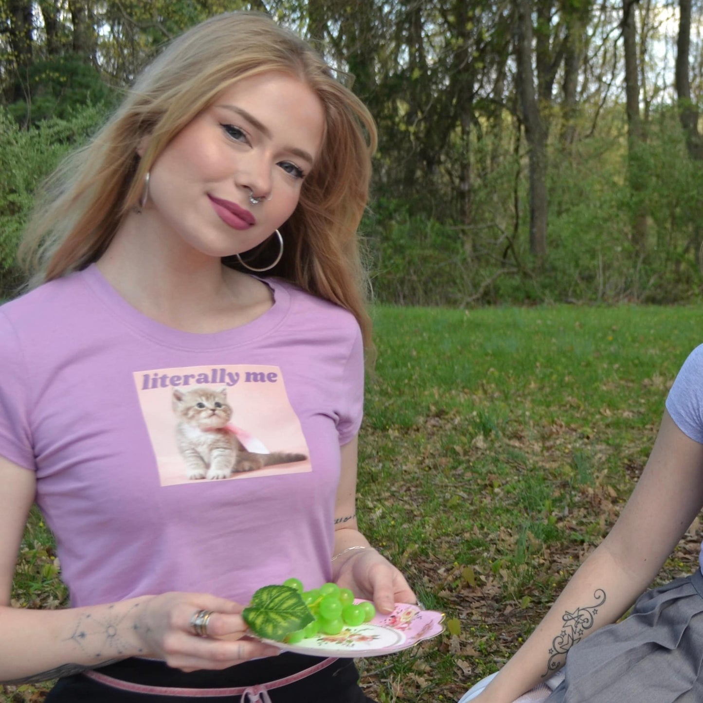 a woman holding a plate with a cat on it