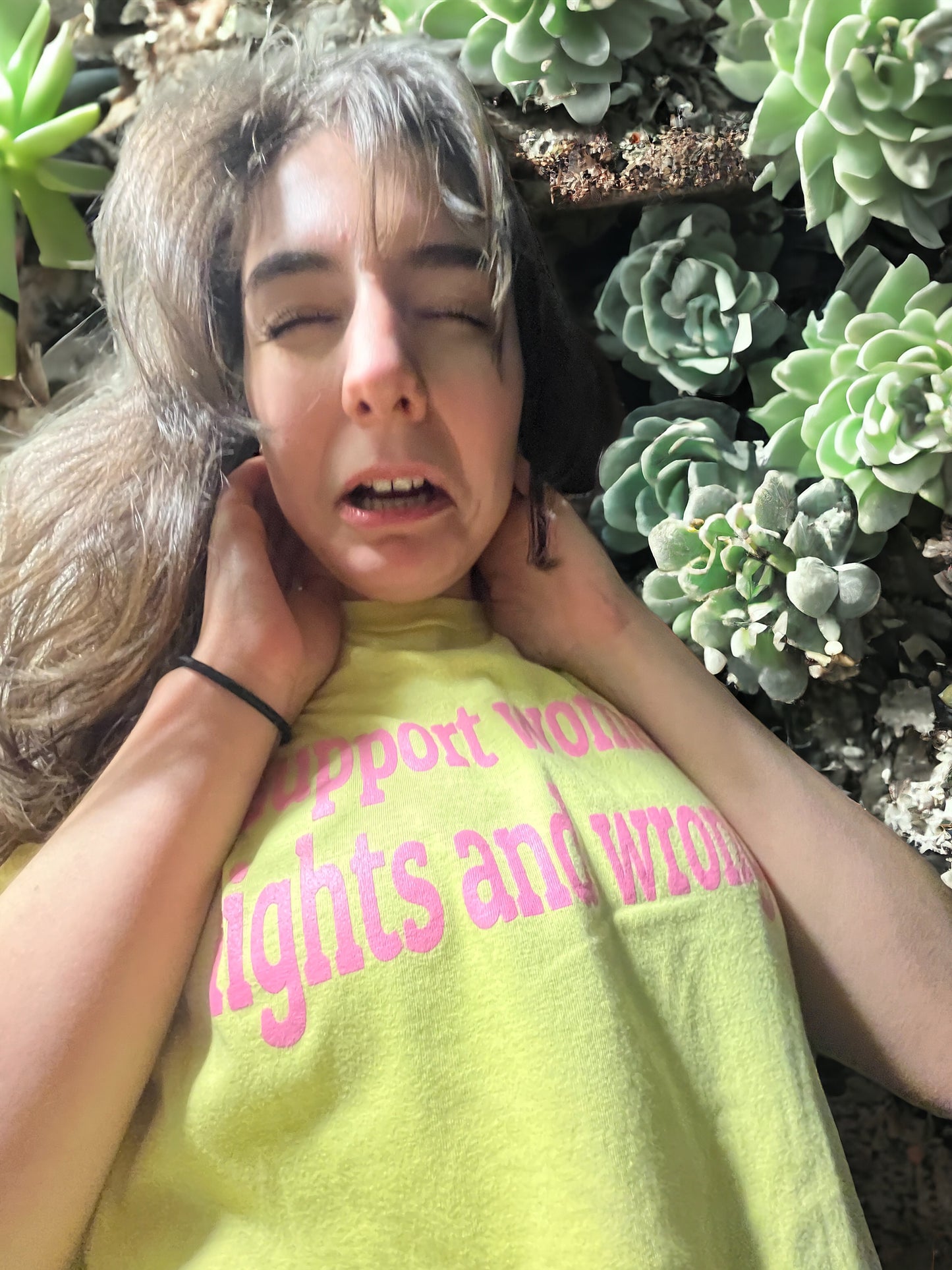 a woman laying on the ground with her eyes closed