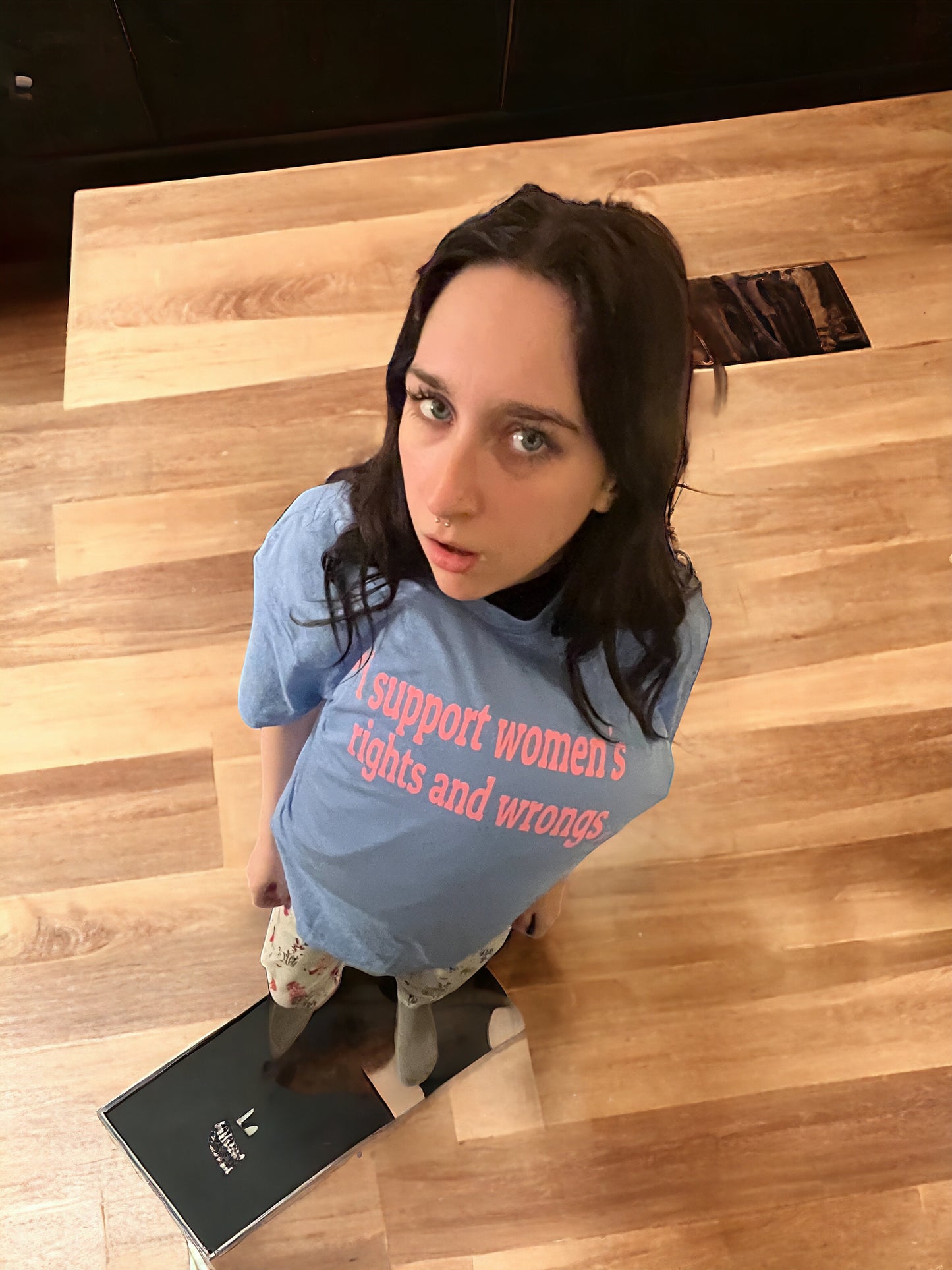 a woman sitting on the floor with a skateboard