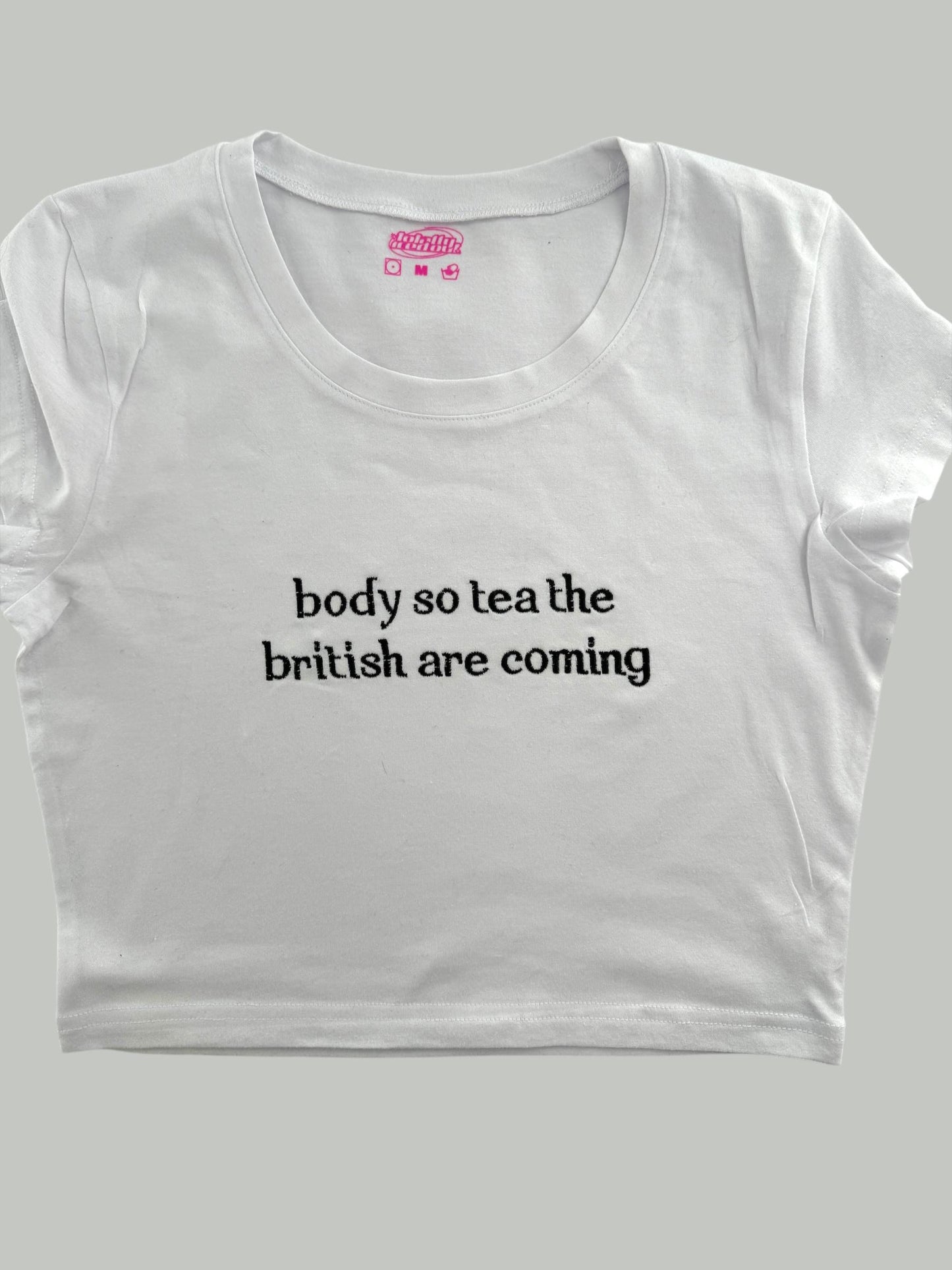 a white t - shirt that says body so tea the british are coming