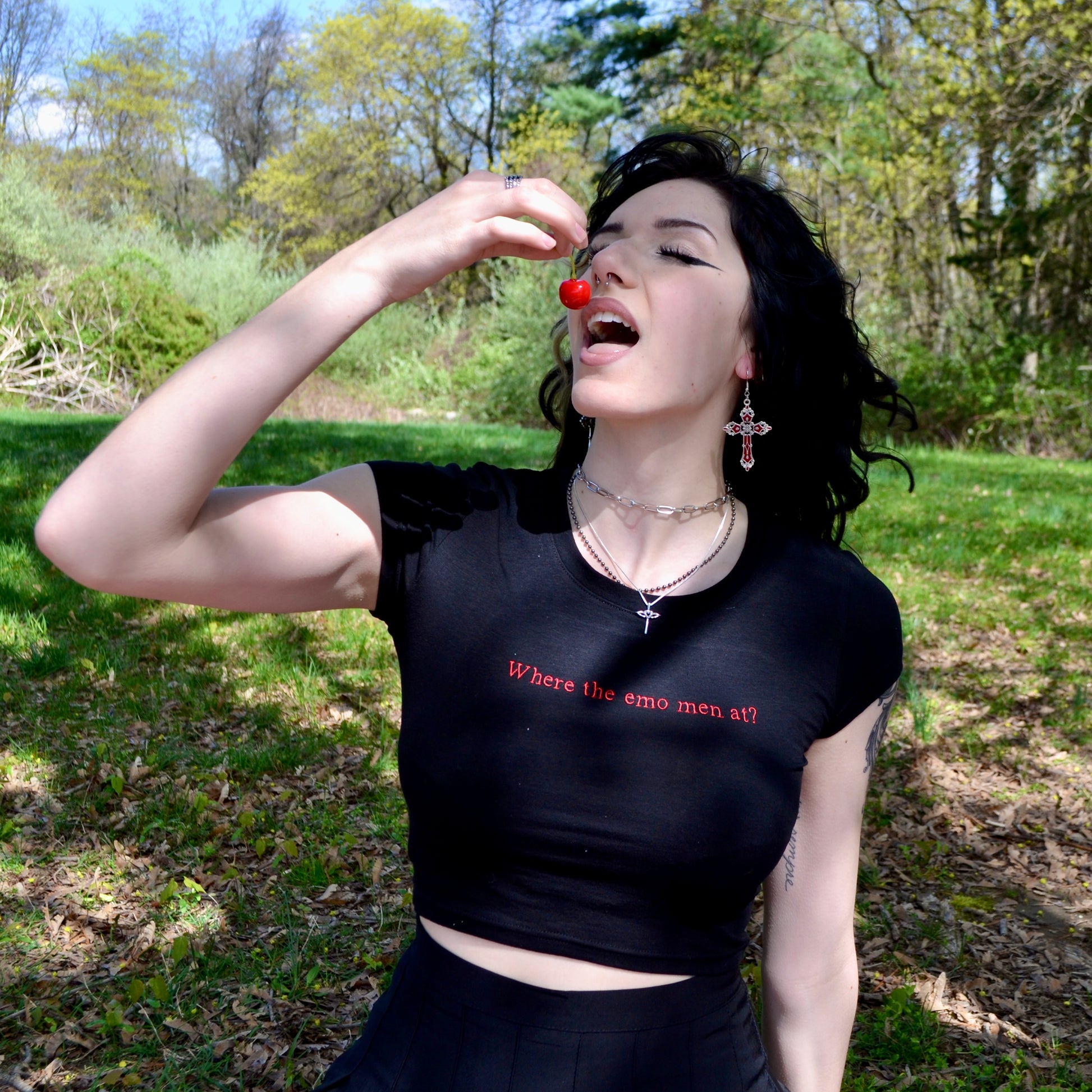 a woman in a black shirt is holding a red object