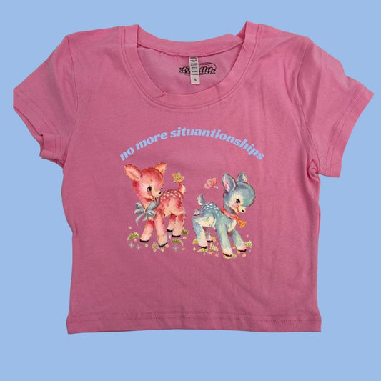 a pink t - shirt with a picture of two small animals on it