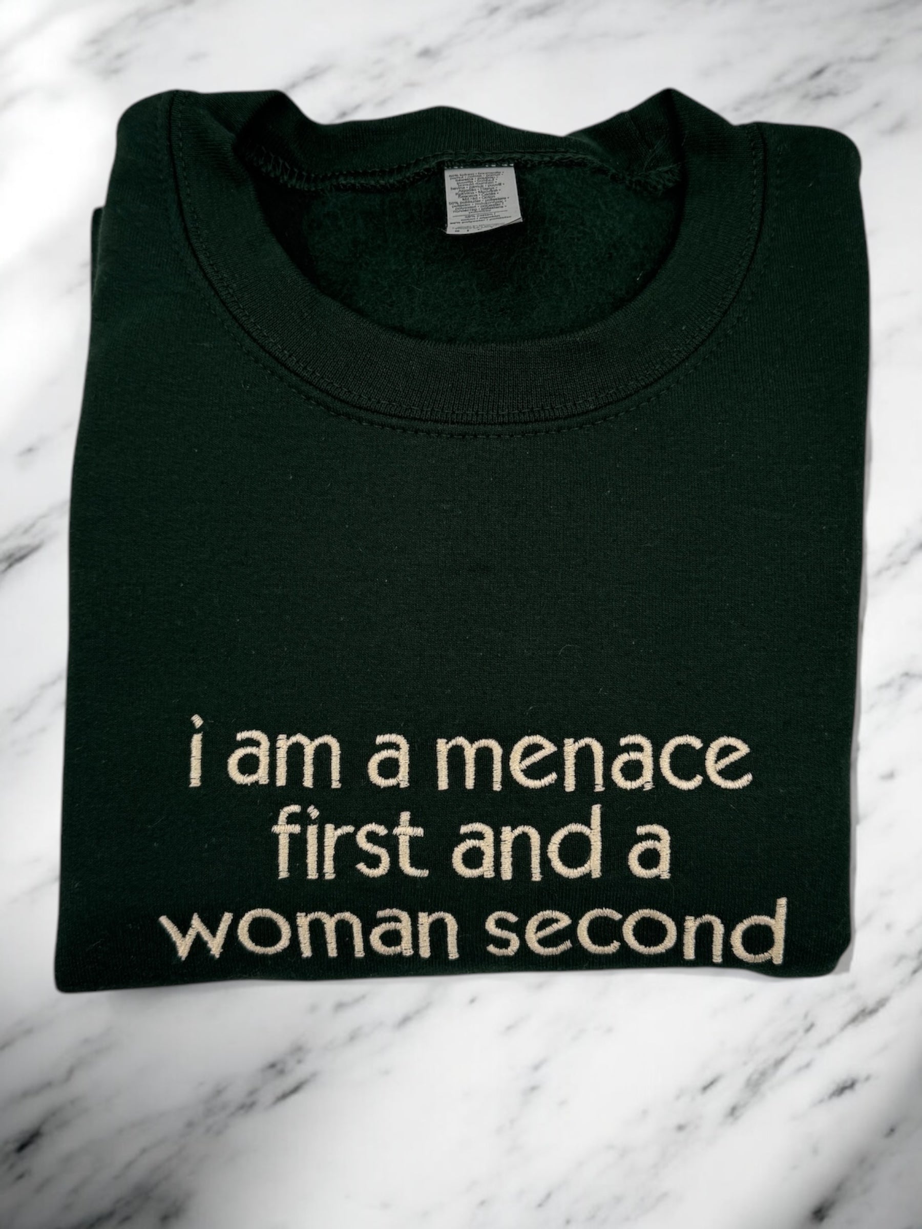 a t - shirt that says i am a menache first and a woman second