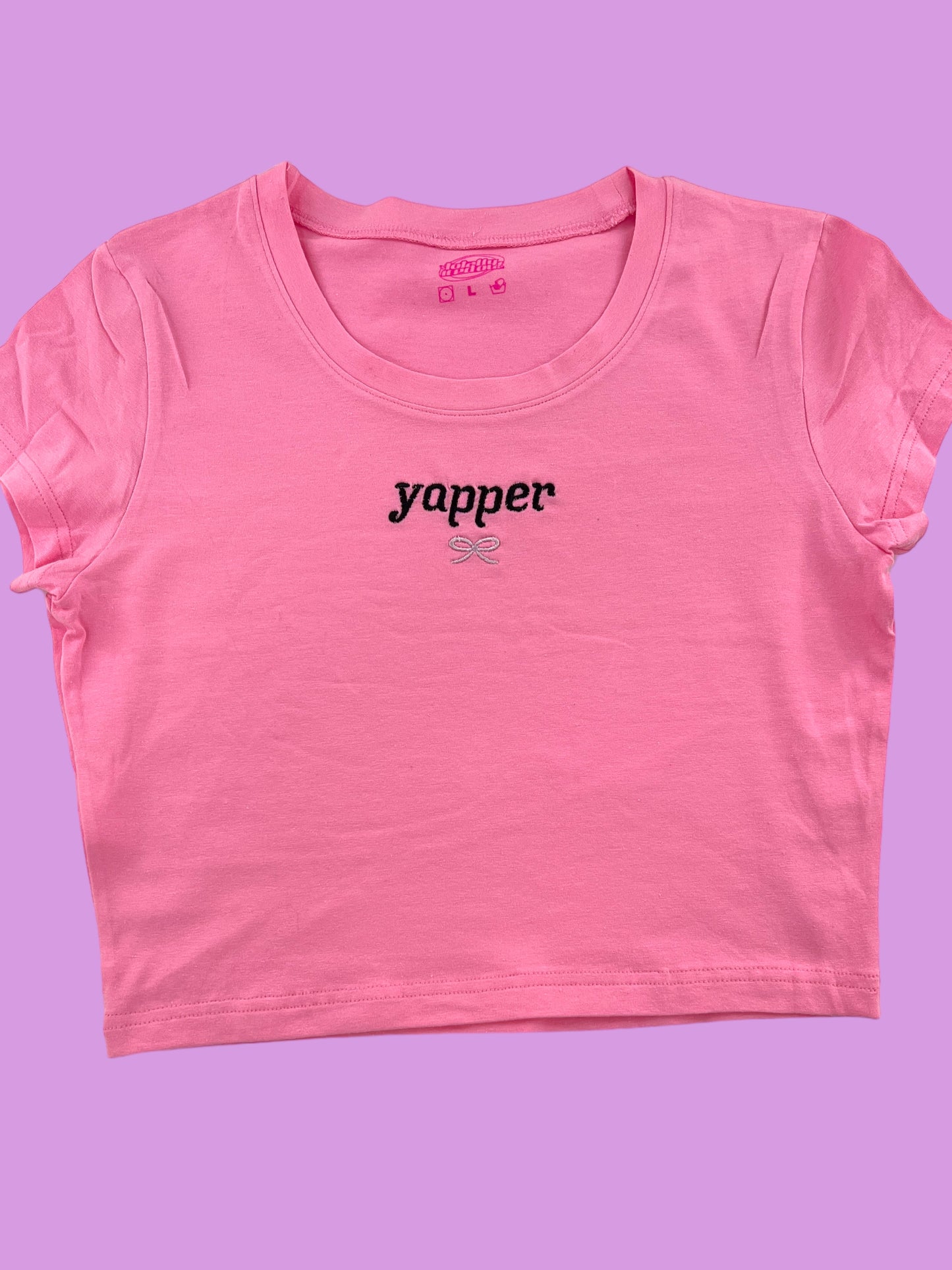 a pink t - shirt with the word yapper printed on it