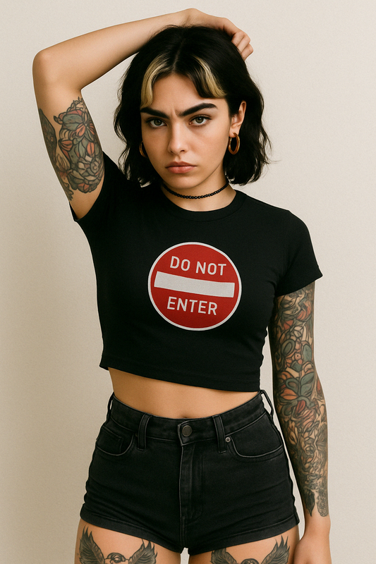 a woman with tattoos and a don't enter sign on her shirt