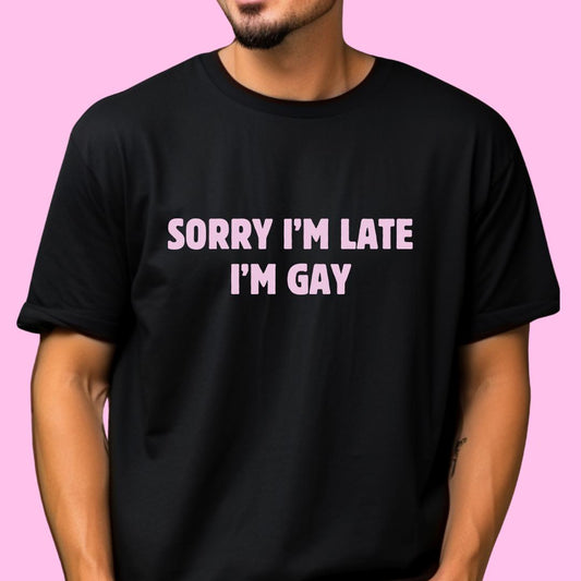 a man wearing a black shirt that says sorry i'm late i'm