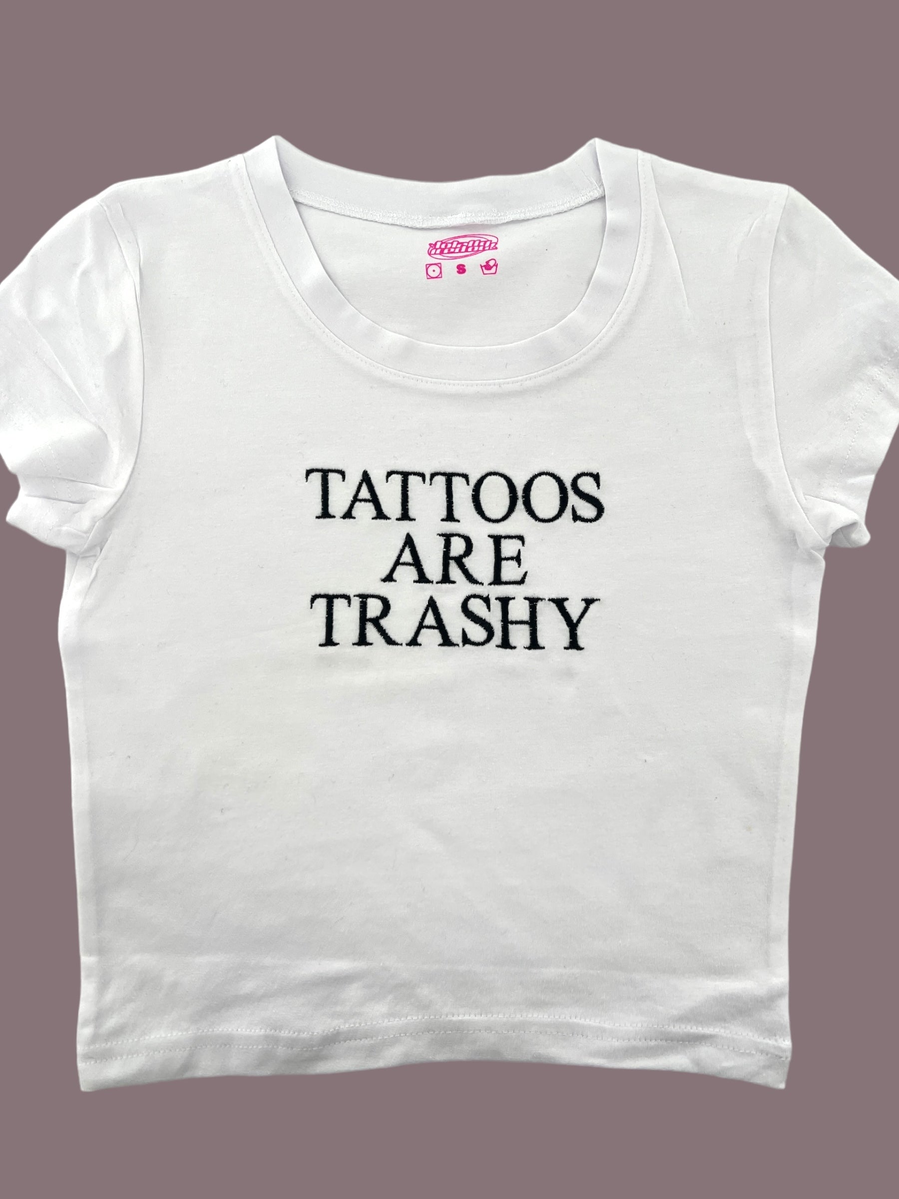 a white t - shirt that says tattoos are trashy