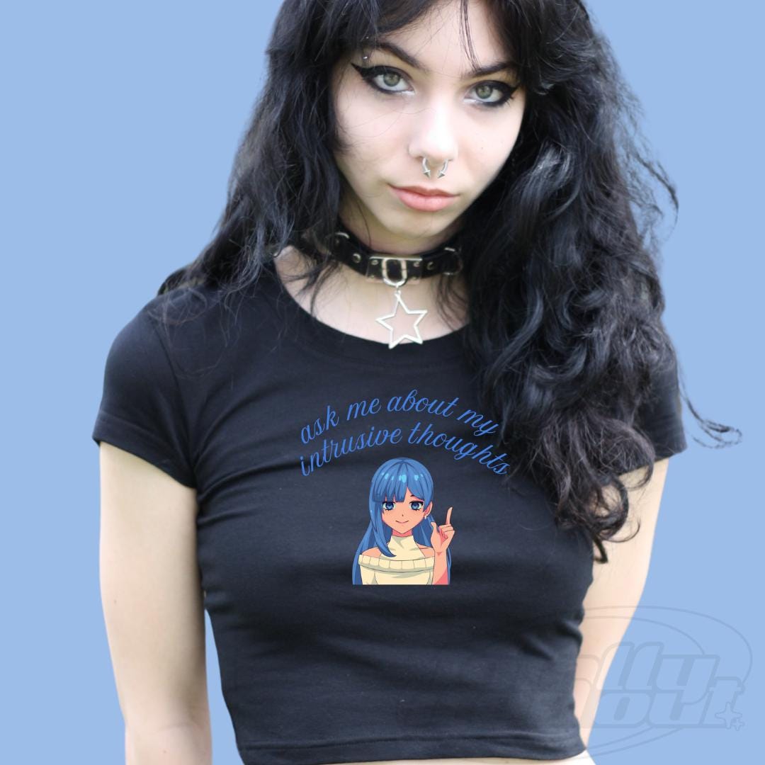 a woman wearing a black shirt with a picture of a girl on it