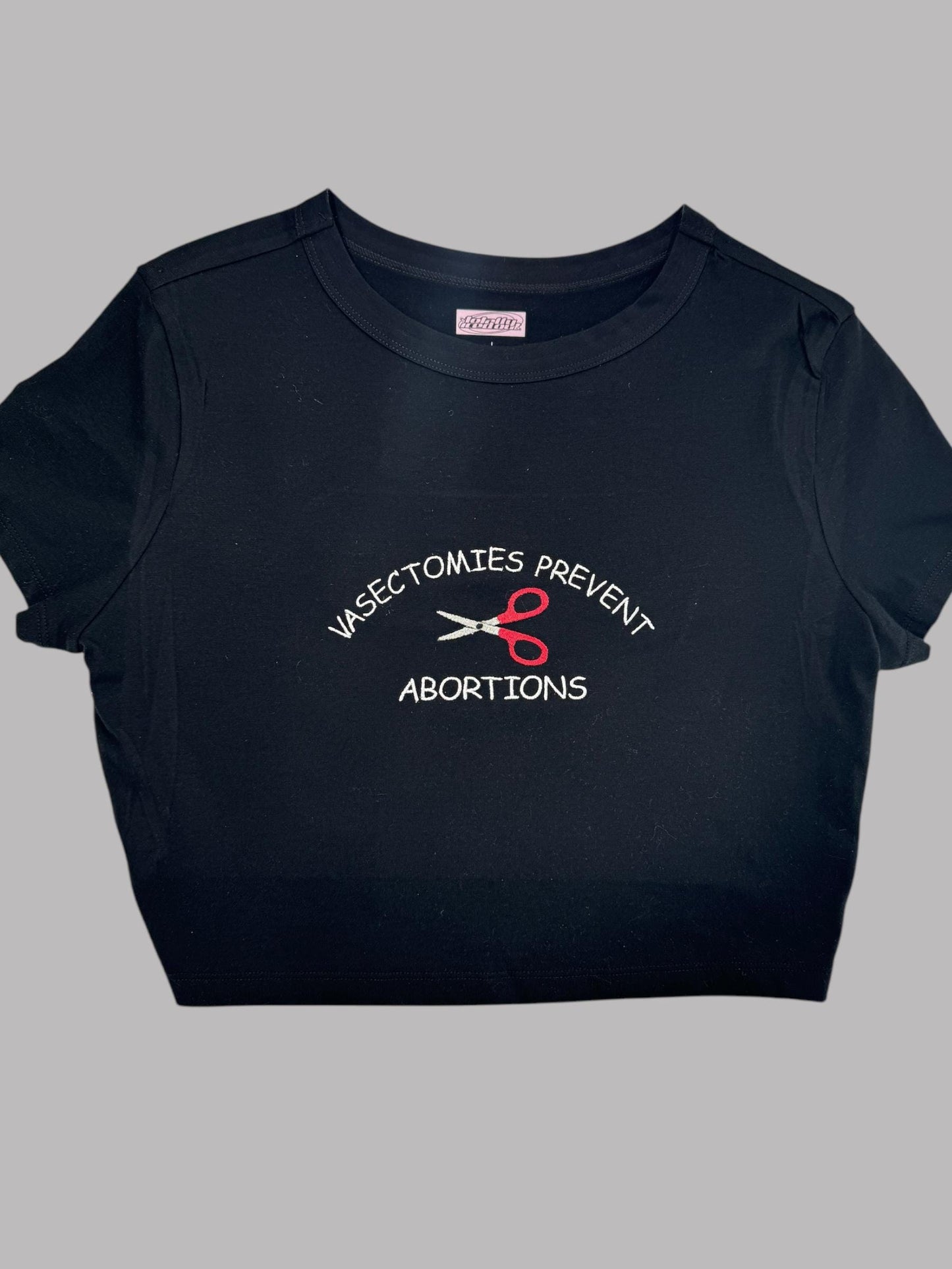 a black t - shirt with scissors on it