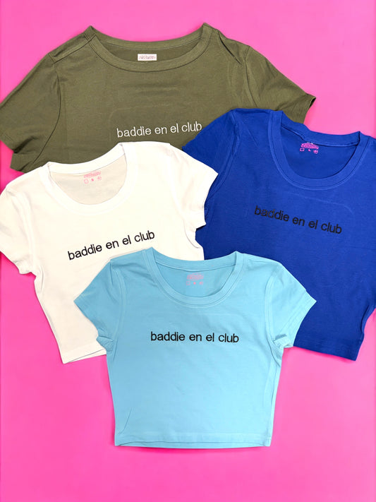 a group of three t - shirts sitting on top of a pink surface