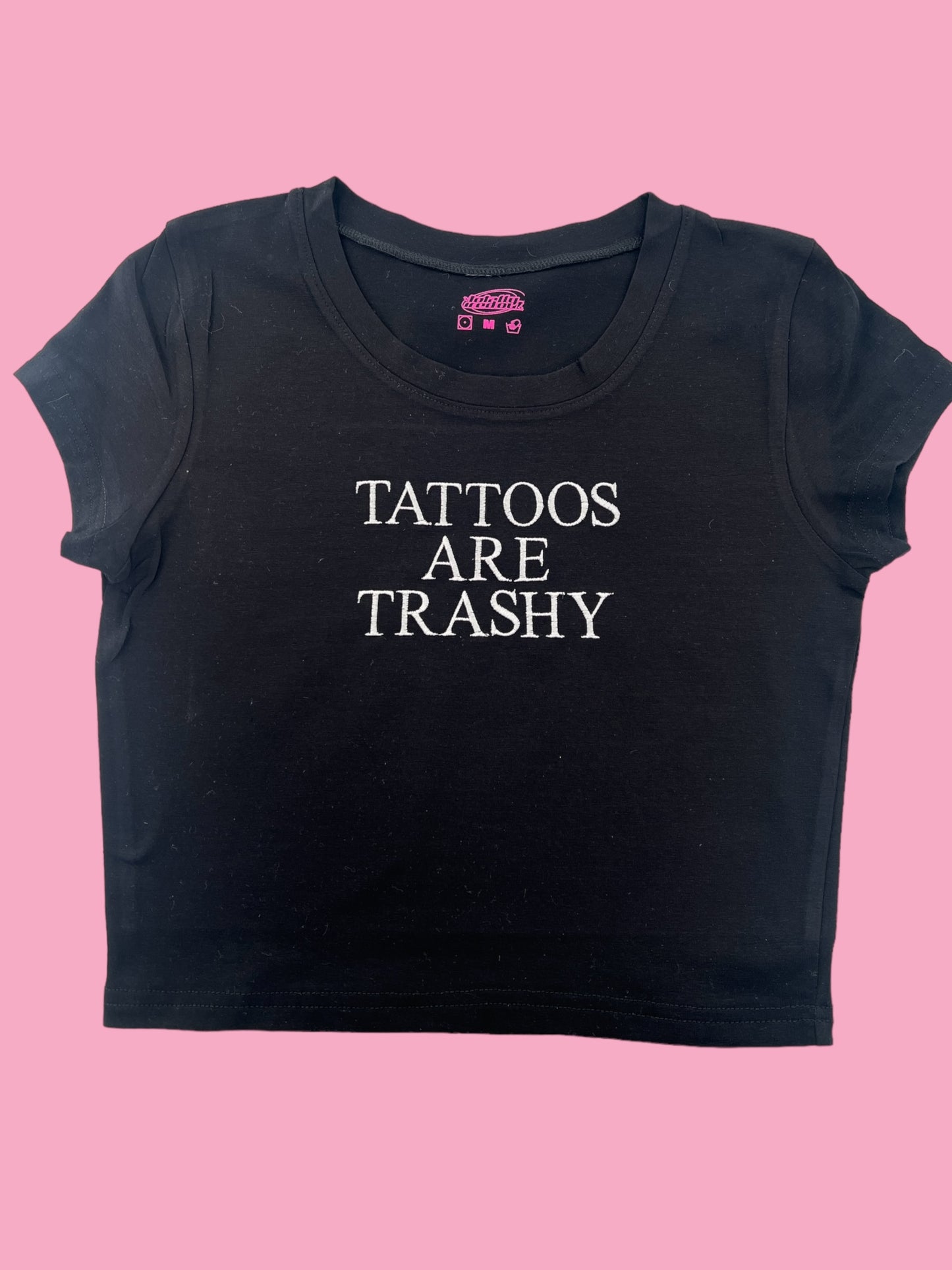 a black shirt that says tattoos are trashy
