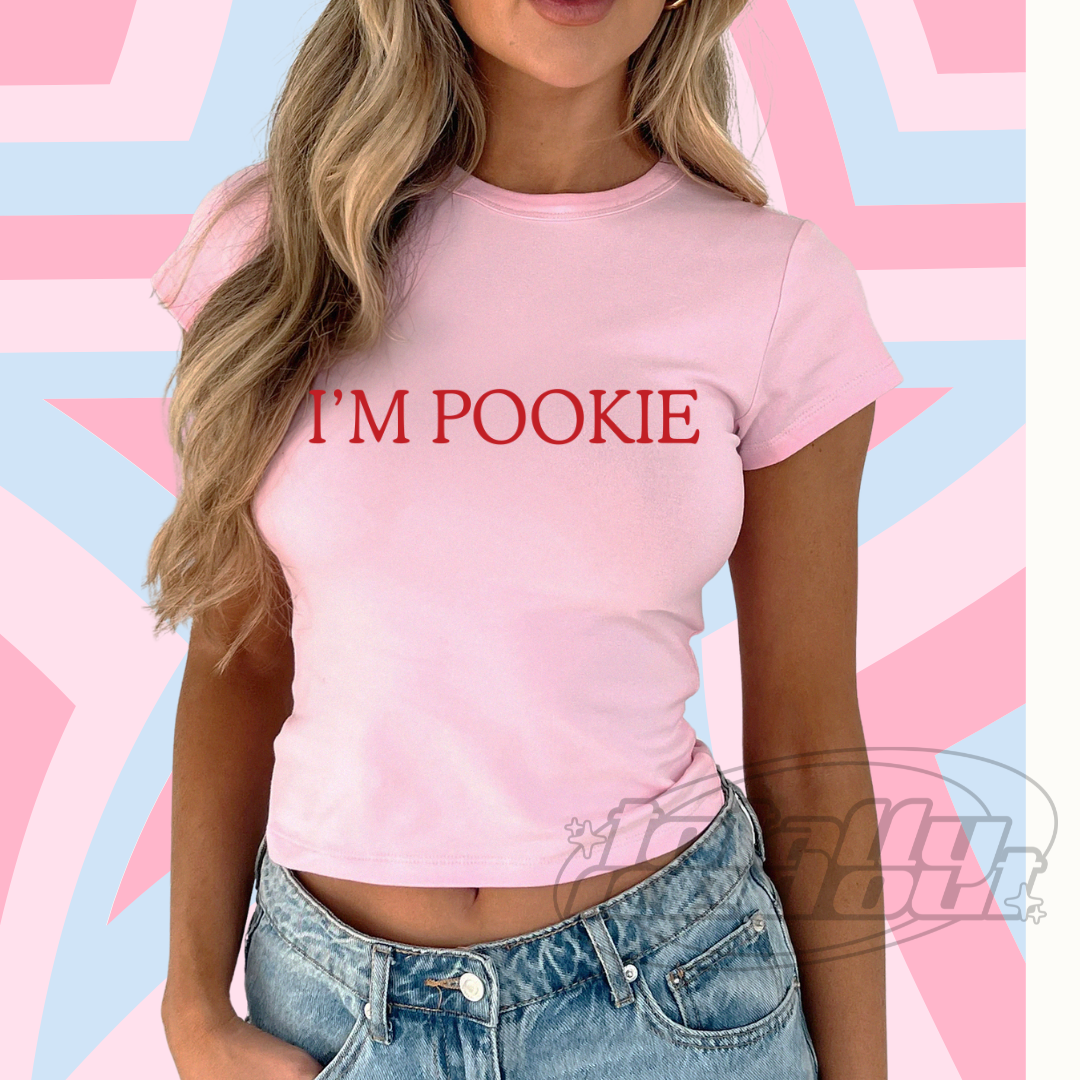 a woman wearing a pink shirt that says i'm pokie