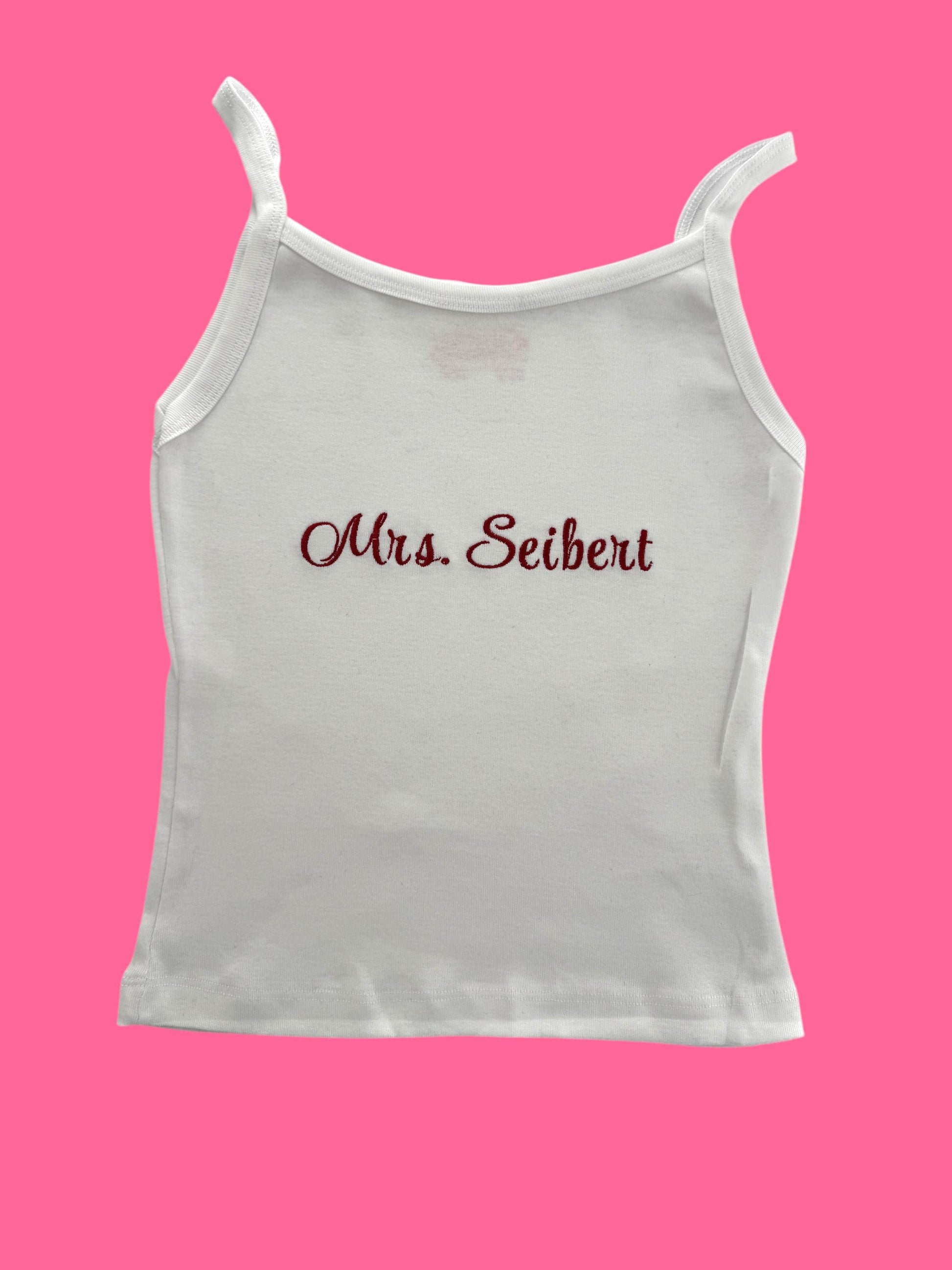 a white tank top with the word mrs seibet printed on it