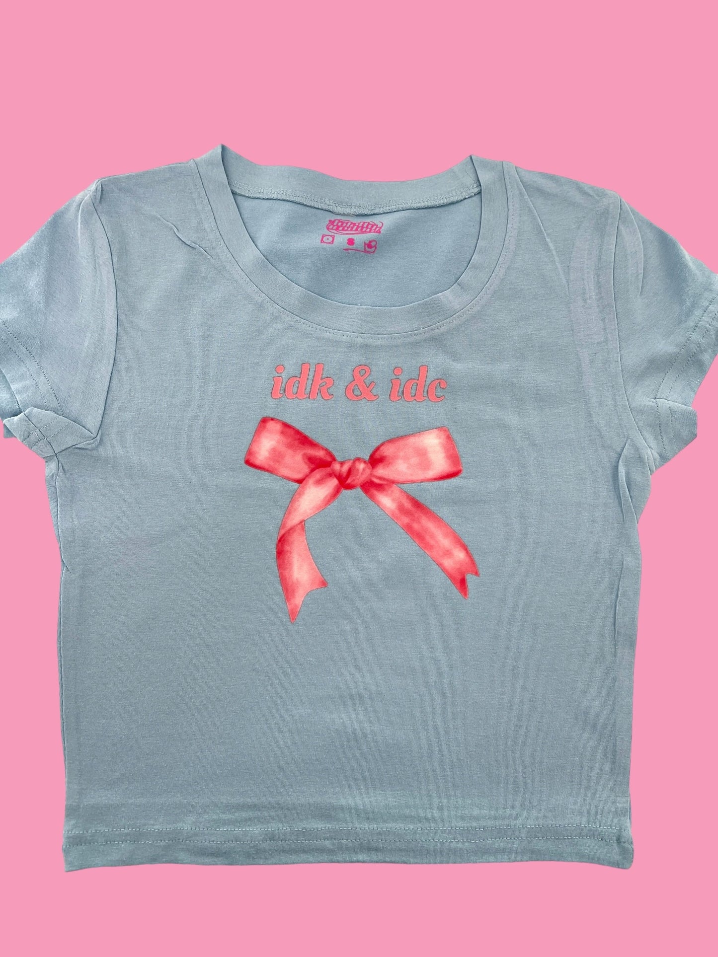a blue t - shirt with a red bow on it