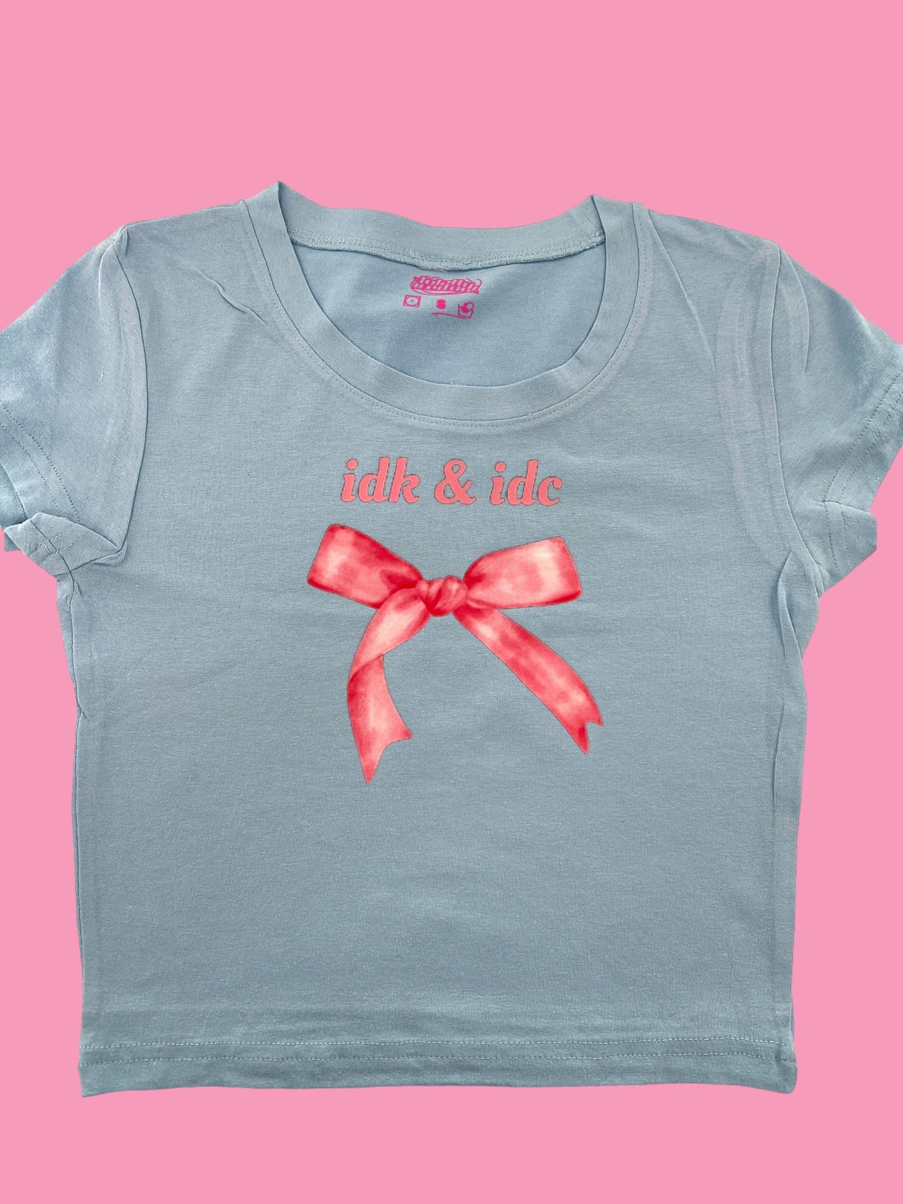 a blue t - shirt with a red bow on it