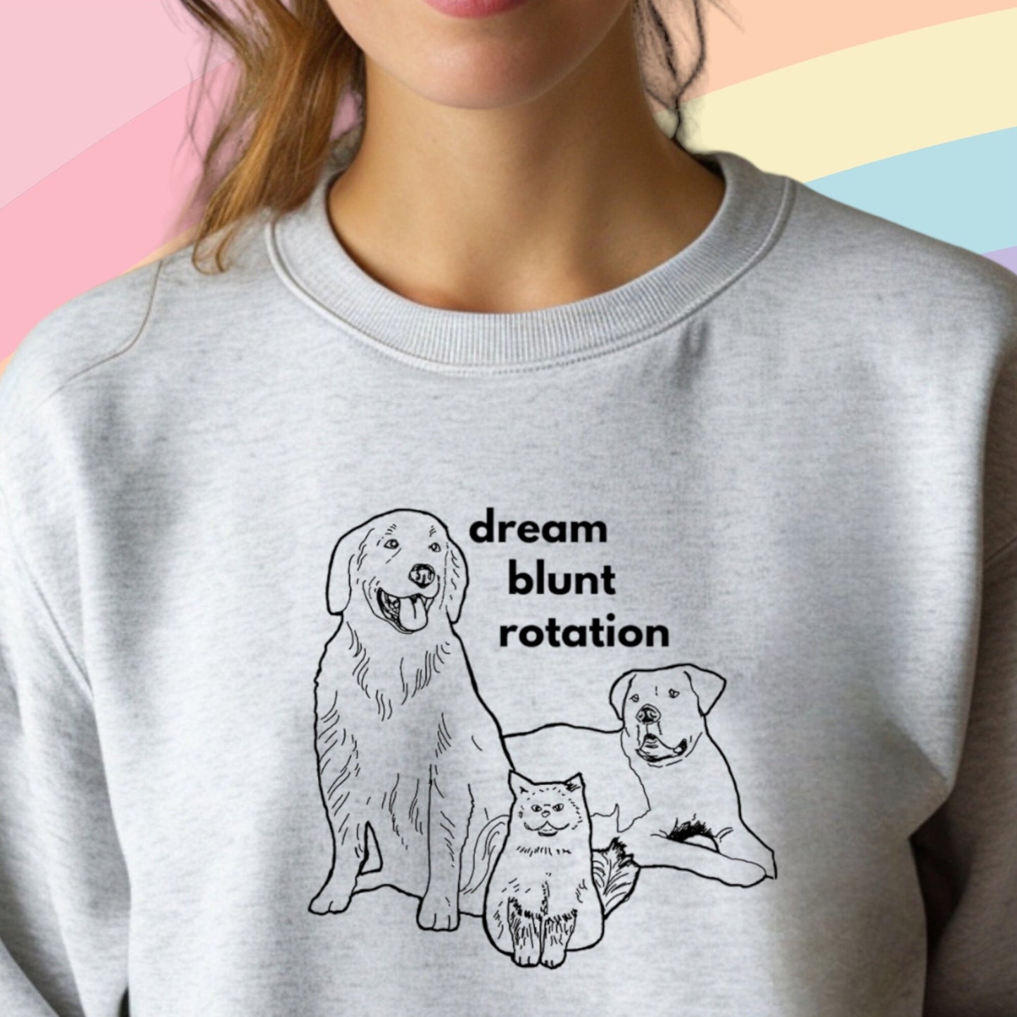 a woman wearing a sweatshirt with a picture of two dogs on it