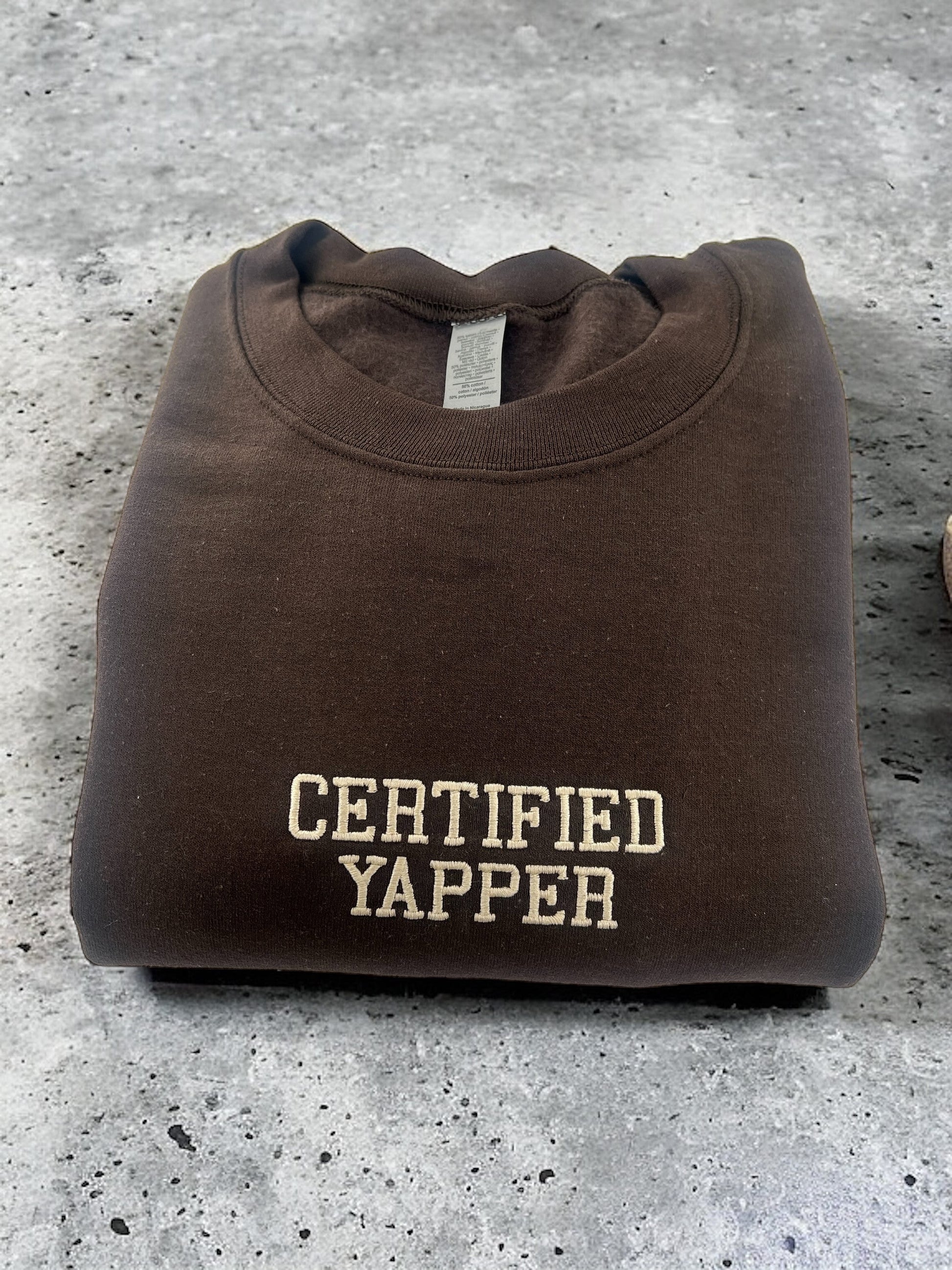 a brown t - shirt with the words certified yapper on it