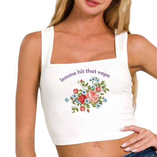 a woman wearing a white tank top with flowers on it