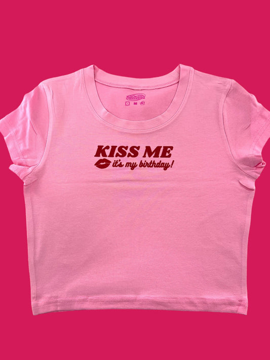 a pink t - shirt with the words kiss me on it