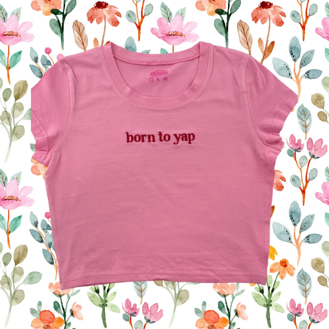 a pink shirt that says born to yap on it