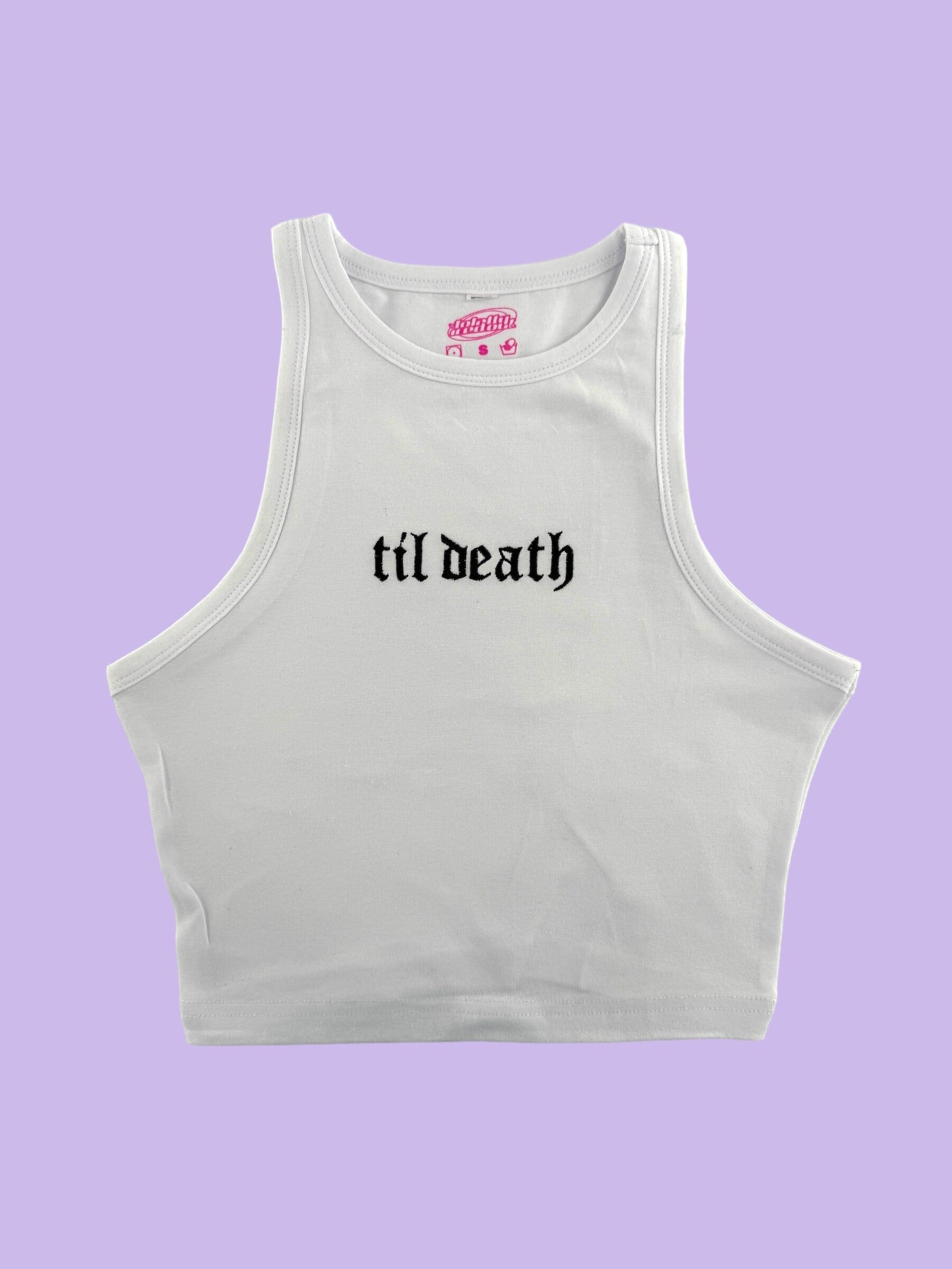 a white crop top with the word til death printed on it