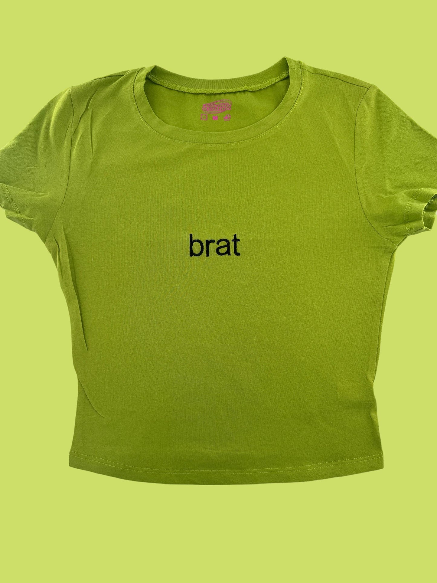 a green t - shirt with the word brat on it