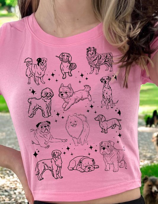 a woman wearing a pink shirt with dogs on it