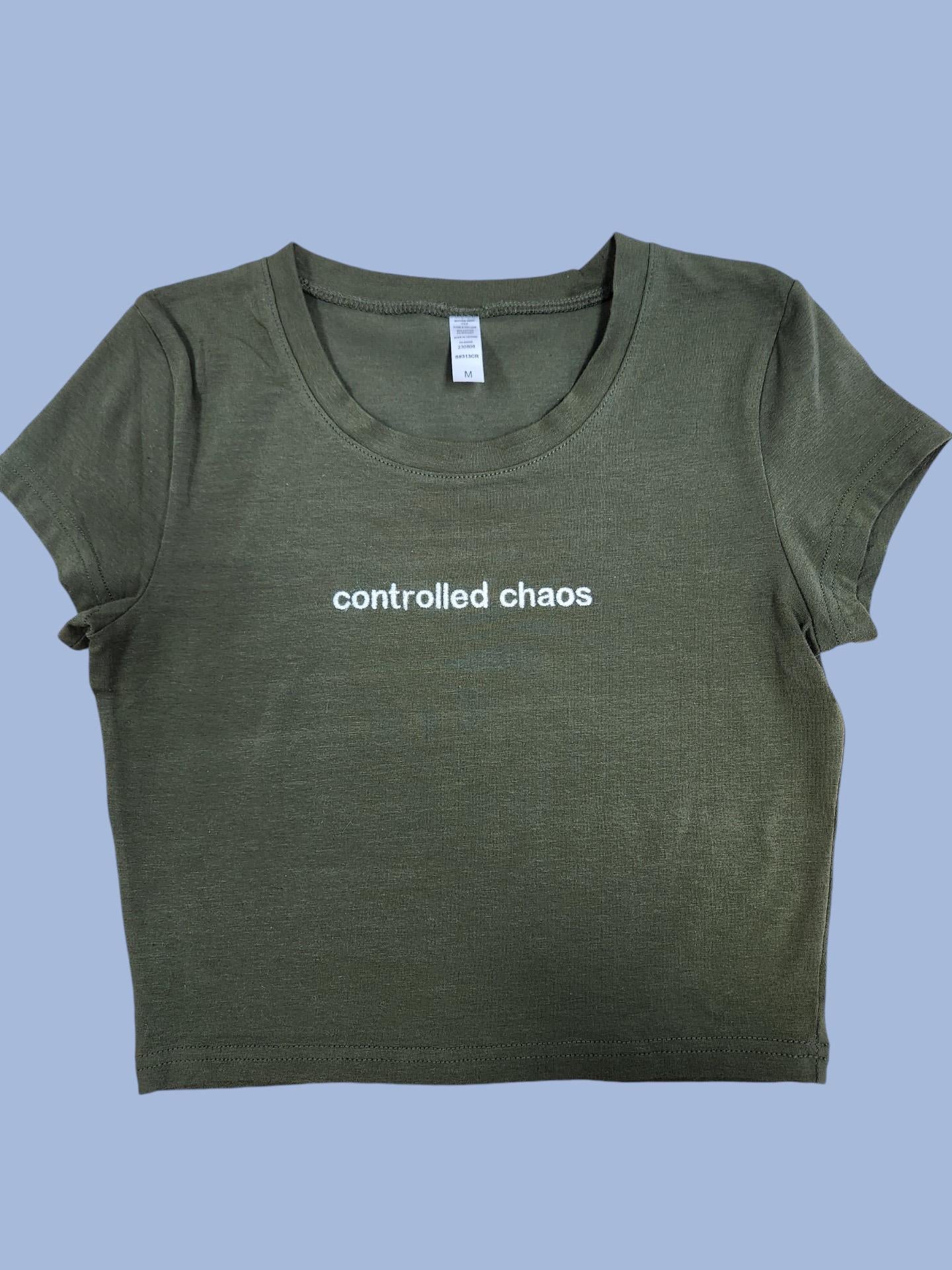 a green t - shirt with the words controlled chaos printed on it