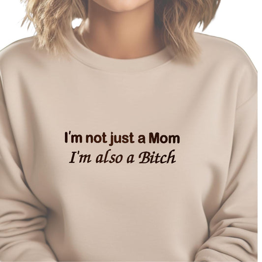 a woman wearing a sweatshirt that says i&#39;m not just a mom i &#39;