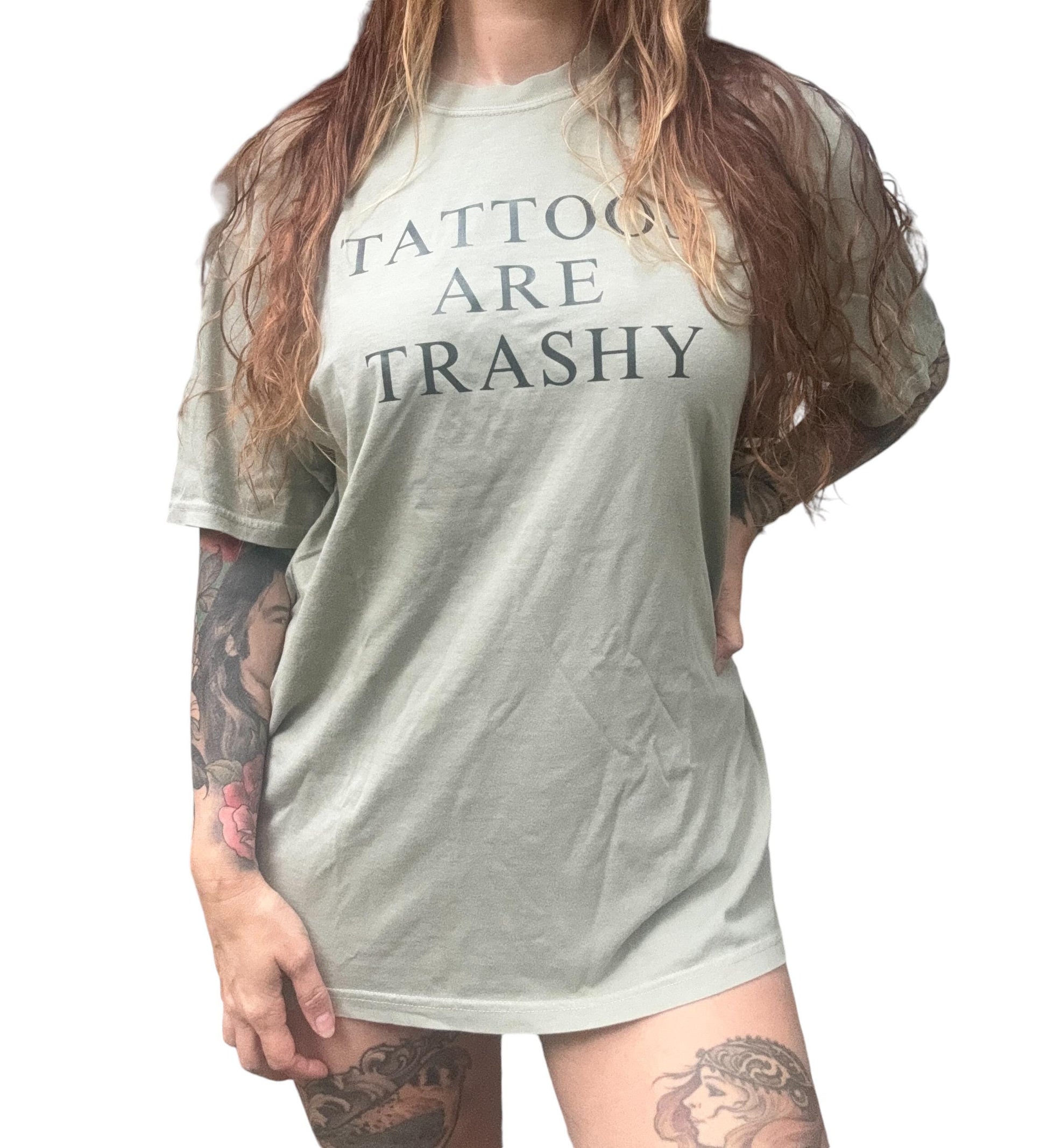 a woman with long hair wearing a tattoo t - shirt