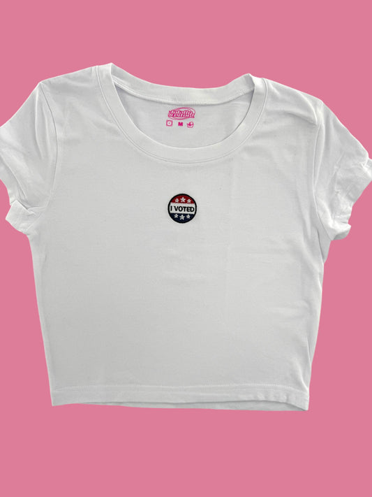 a white crop top with a pink background