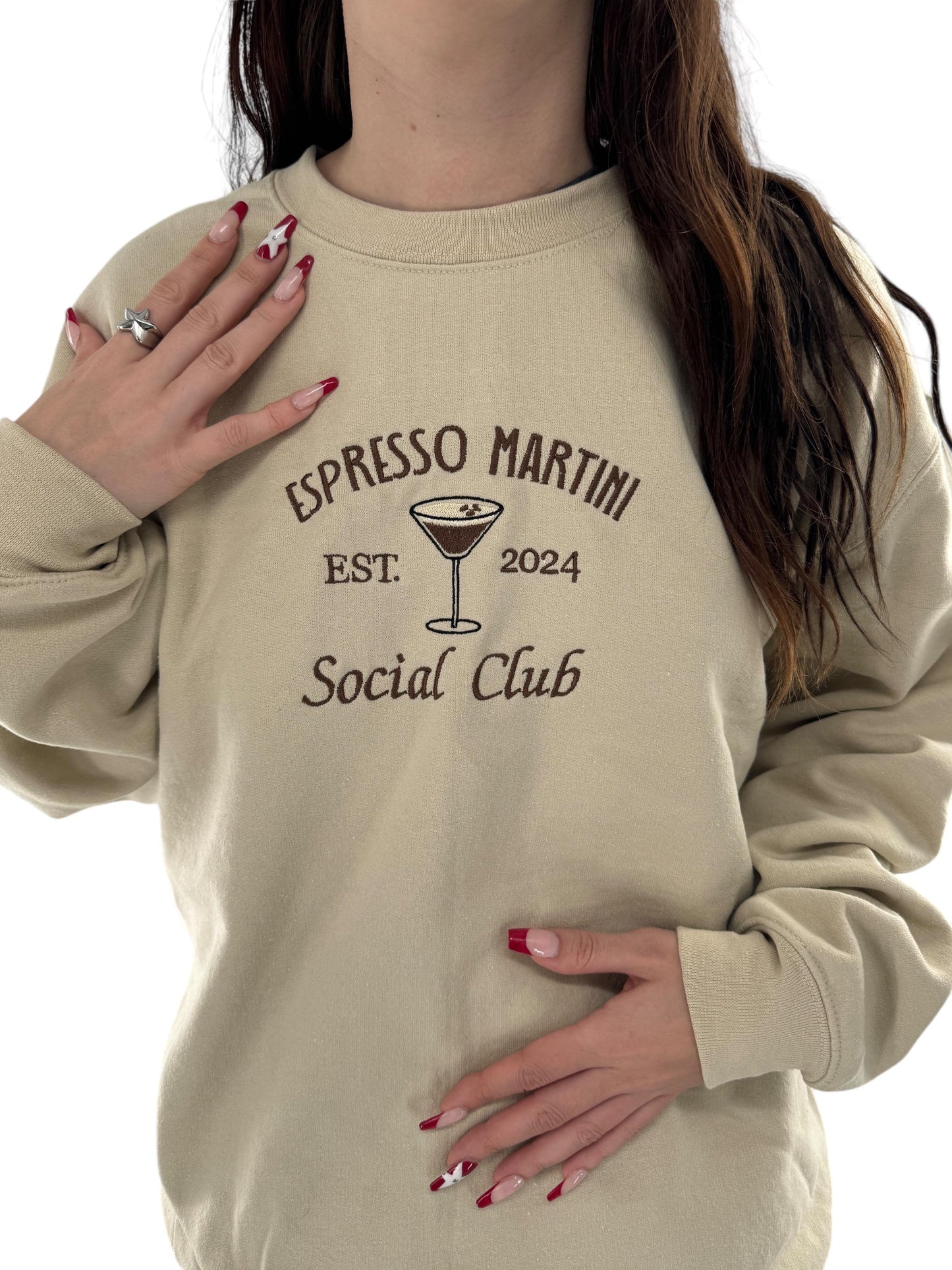 a woman wearing a sweatshirt that says espresso martini social club