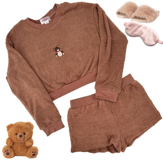 a teddy bear is next to a sweater and slippers