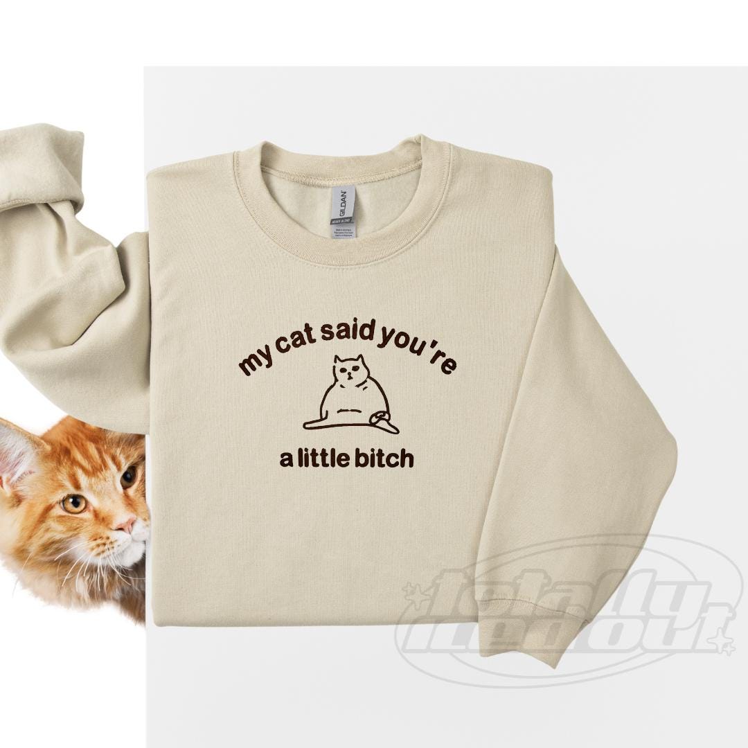 a cat wearing a sweater that says, my cat said you&#39;re a little