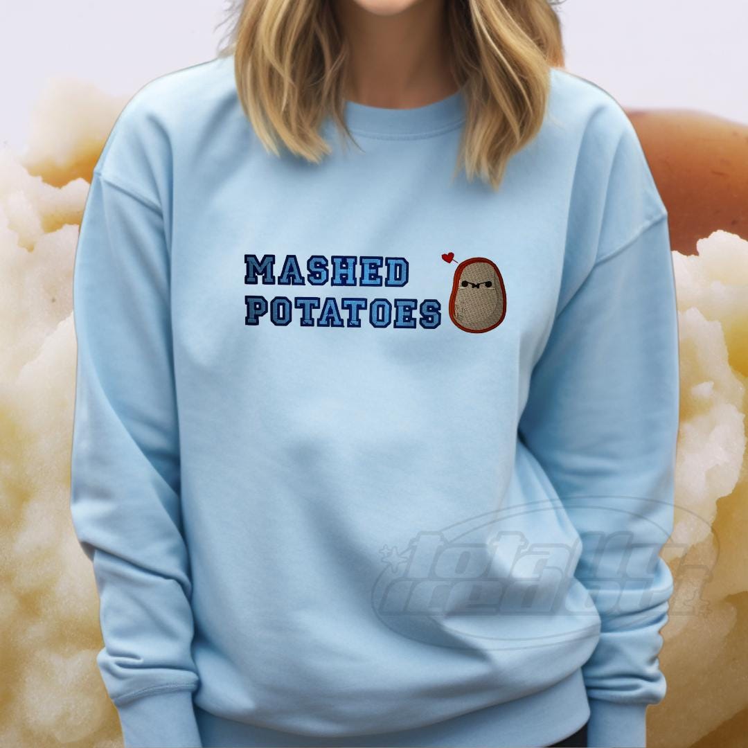 a woman wearing a blue sweatshirt that says mashed potatoes