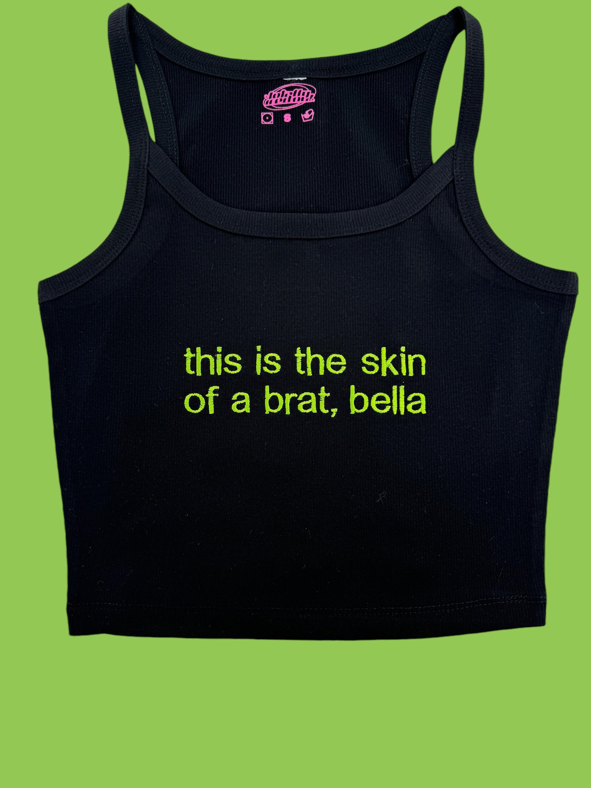 a black tank top that says, this is the skin of a brat, bel