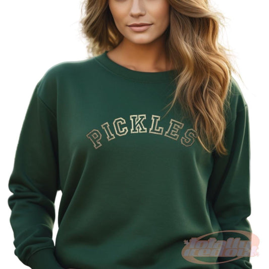 a woman wearing a green sweatshirt with the word pickles on it