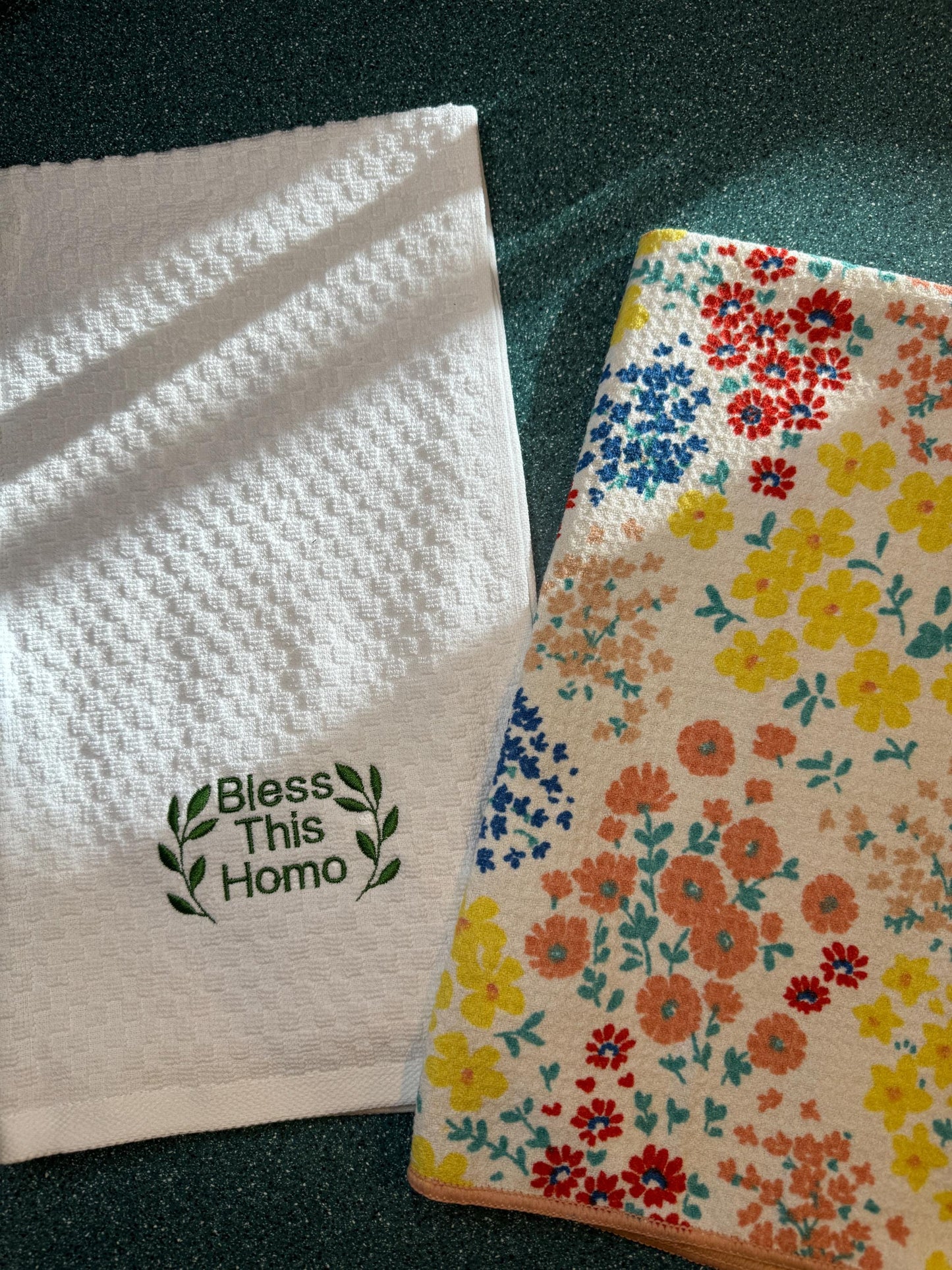 two flowered towels sitting on top of a table