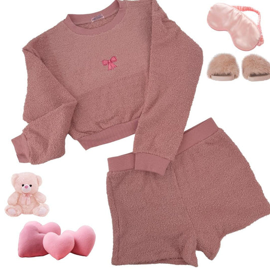 a pink outfit with a teddy bear and a pair of slippers