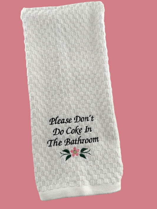 a white towel that says please don't do coke in the bathroom