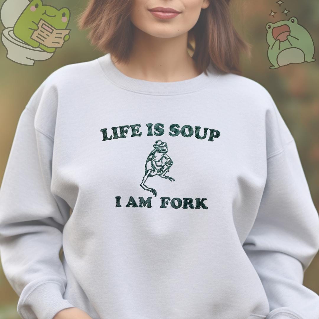 a woman wearing a sweatshirt that says life is soup i am fork