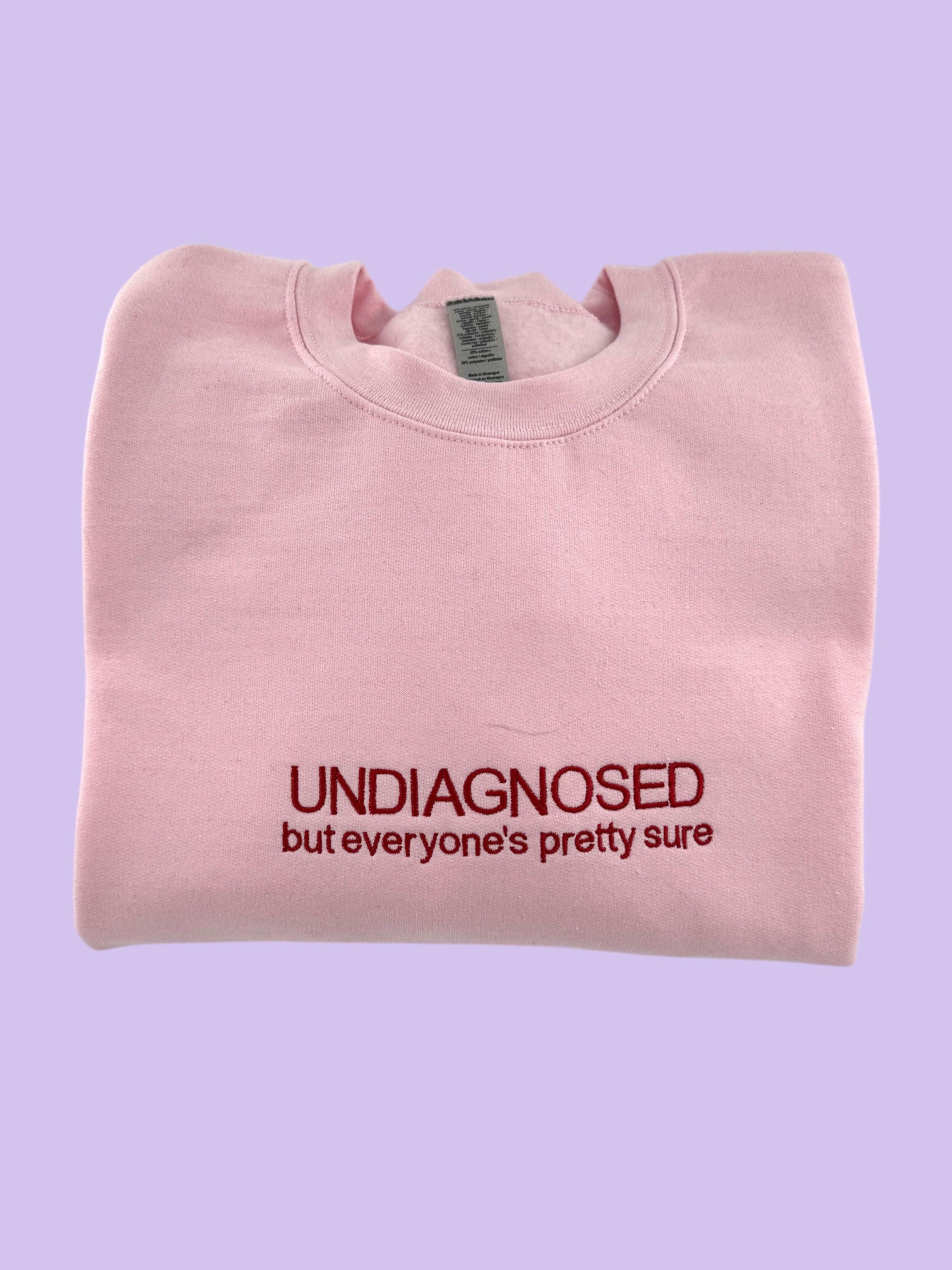 a pink t - shirt with the words undiagnosed but everyone's