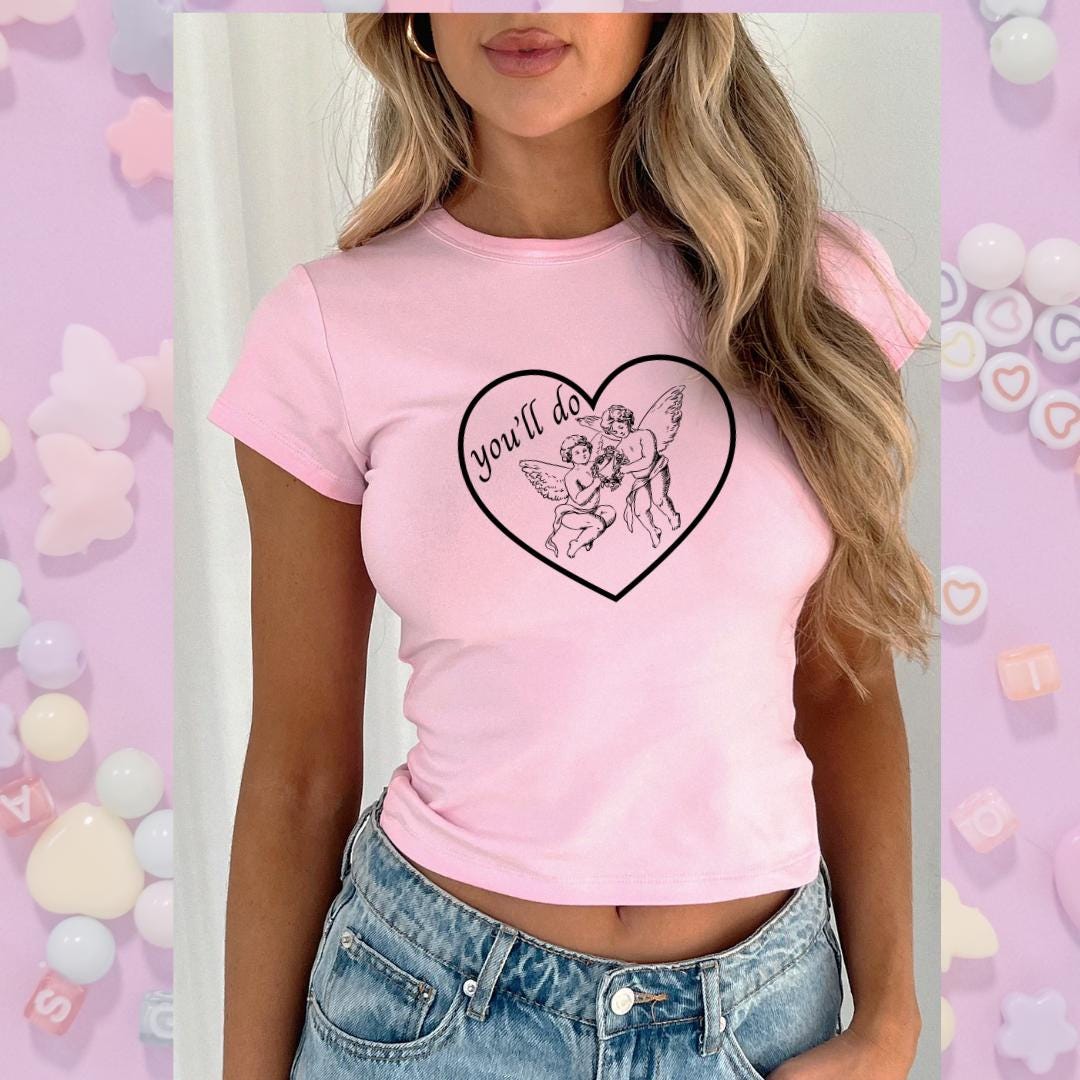 a woman wearing a pink shirt with a heart on it