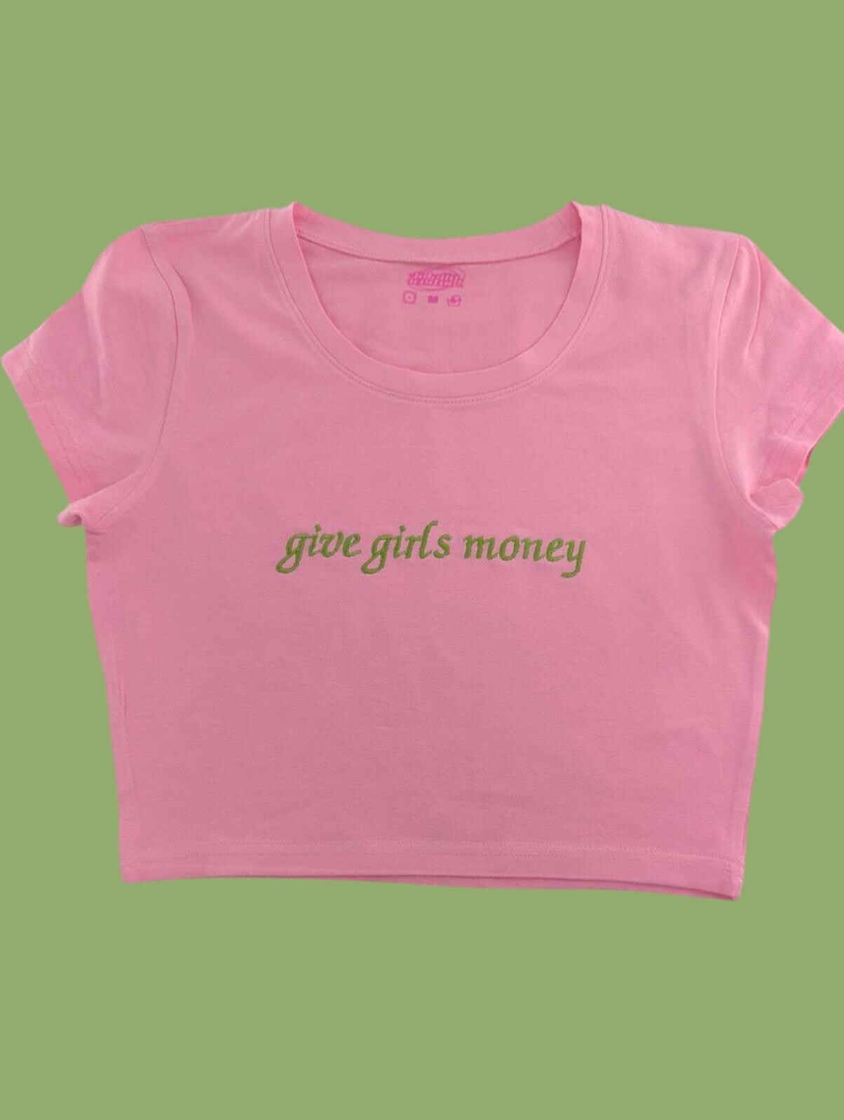 a pink crop top that says,'give girls money '