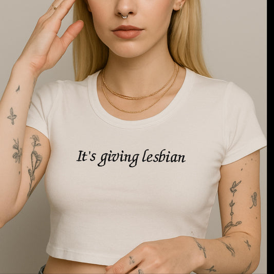 a woman wearing a white shirt has a tattoo on her arm