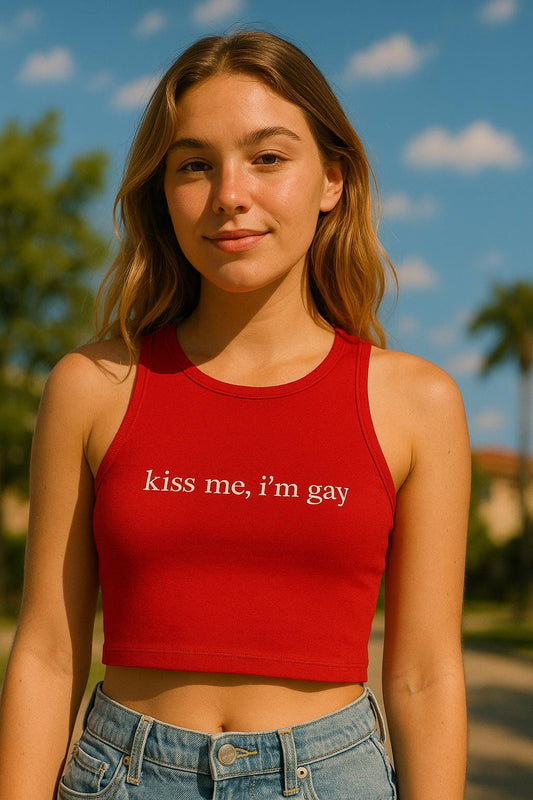a girl in a red crop top that says kiss me, i'm gay