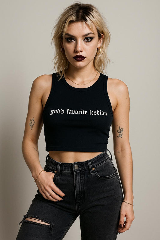 a woman wearing a black crop top and ripped jeans