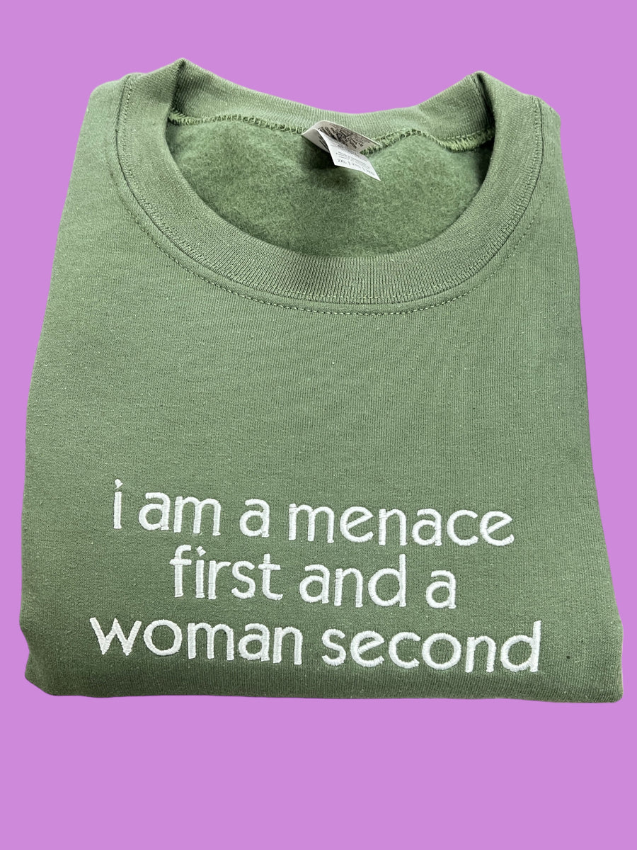 a green t - shirt that says i am a mance first and a woman
