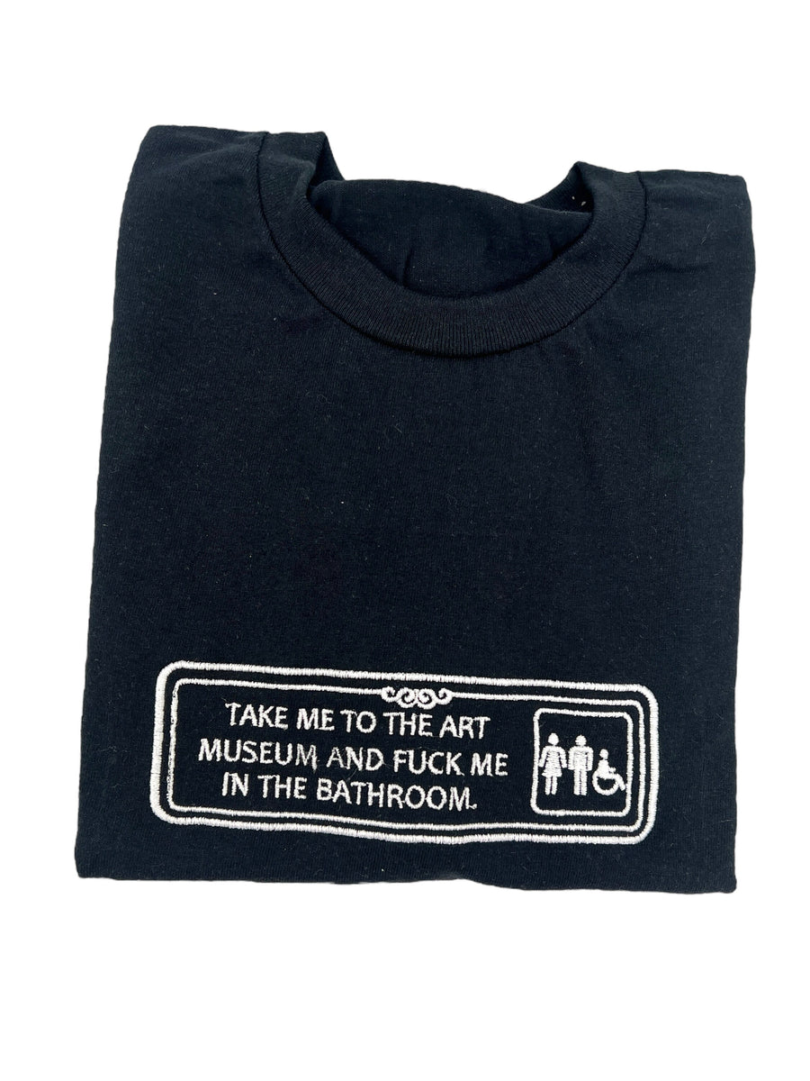 a black t - shirt with a sign that says take me to the museum and